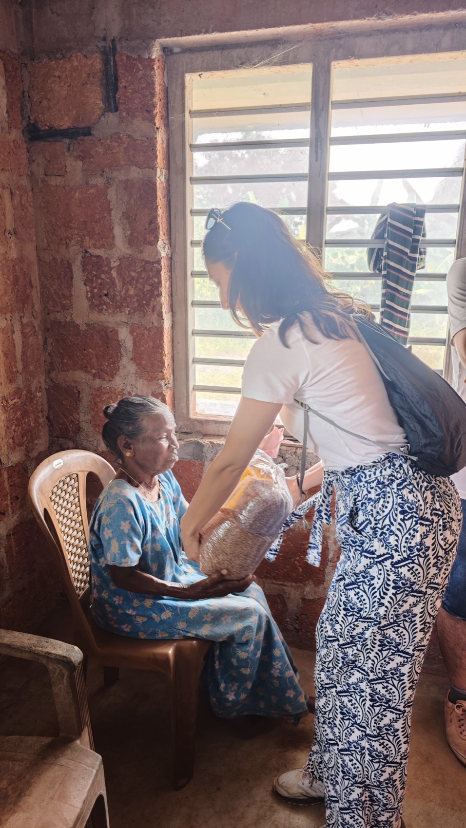 Tending to a homebound elder with medicine and company.